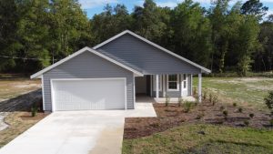 Modern gray house with a two-car garage and front porch.