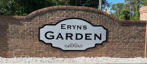 Sign reading 'Eryn's Garden' on a brick wall.